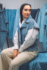 Woman wearing light-wash denim shirt with relaxed