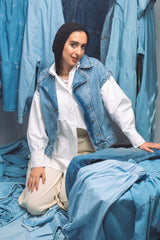 Woman wearing light-wash denim shirt with relaxed fit