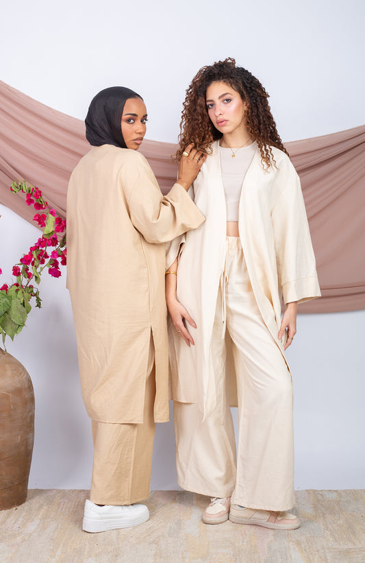 Buy neutral loungewear set online, featuring two women in relaxed beige outfits.